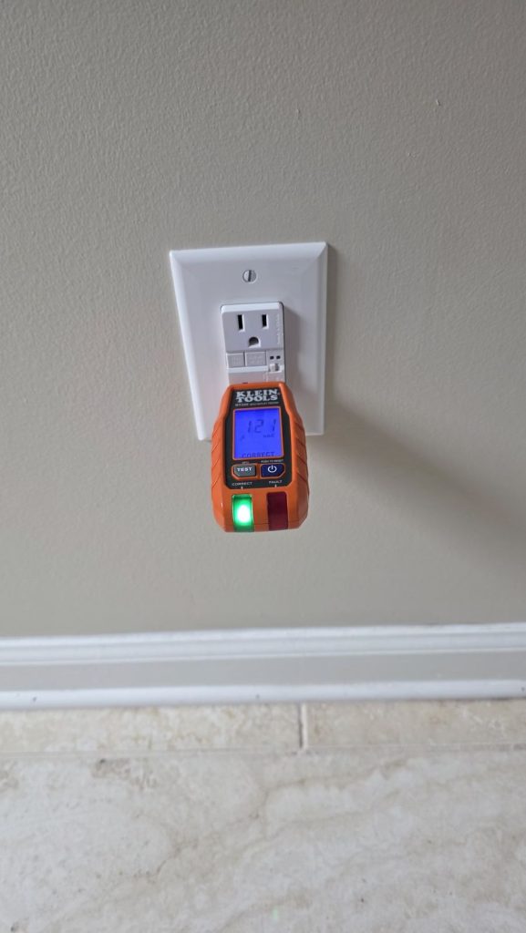 GFCI outlet verified with a receptacle tester showing correct wiring in a Newnan, GA home by Shocking Electric Solutions