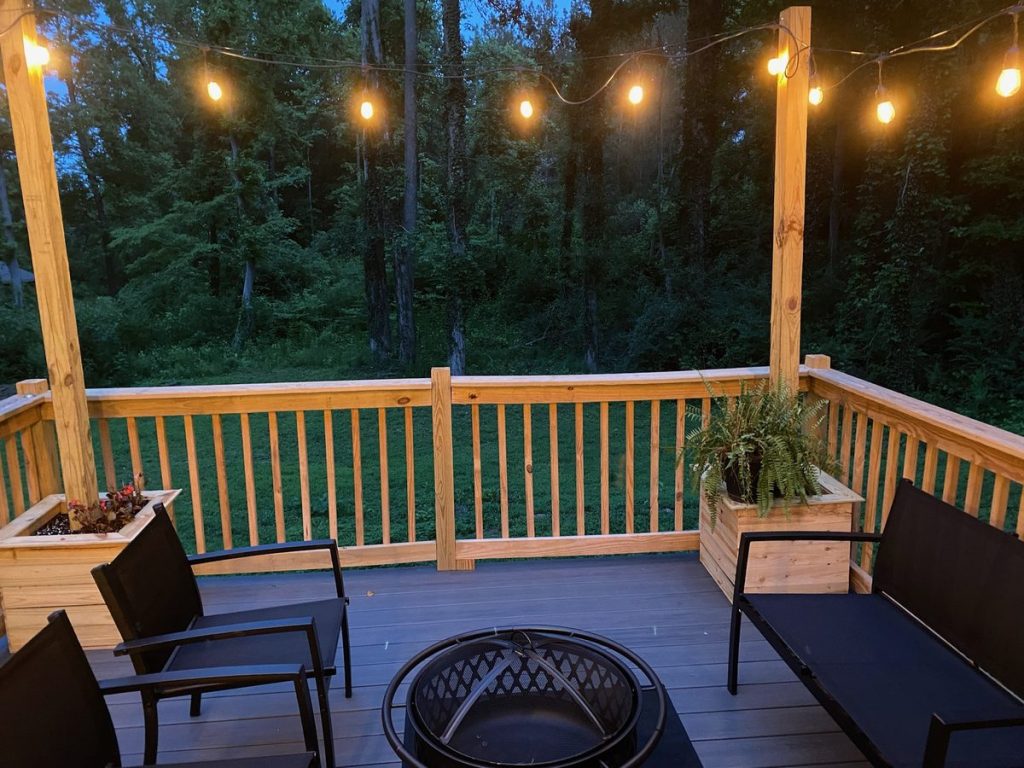 Backyard deck with string lights installed by Shocking Electric Solutions