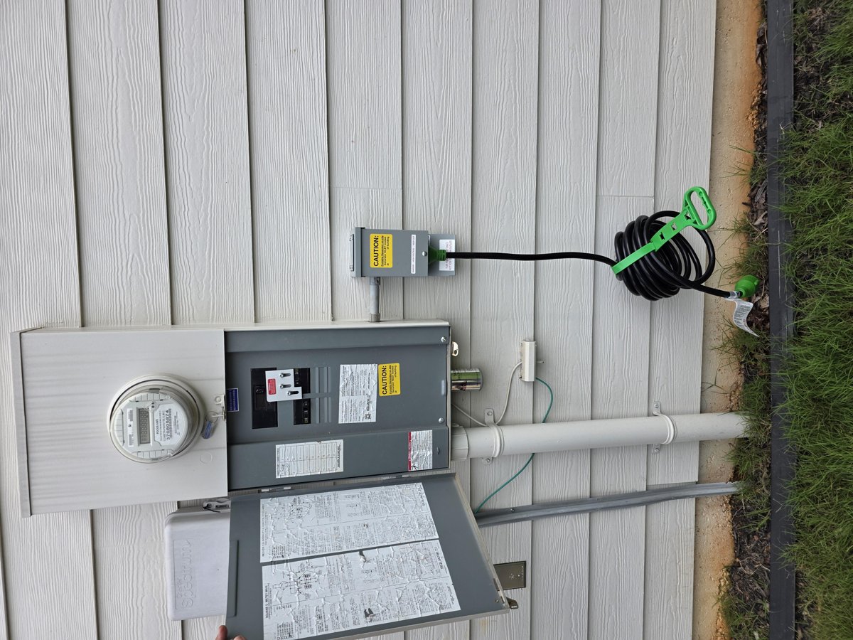 Generator inlet installed next to a meter main on a home by Shocking Electric Solutions