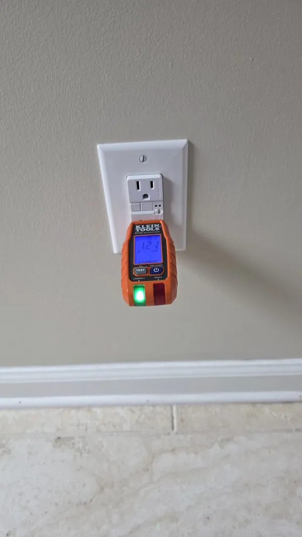 Receptacle tester confirming correct wiring on a GFCI outlet during electrical troubleshooting in a Newnan, GA home by Shocking Electric Solutions