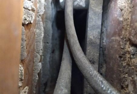 Old cloth-insulated wiring running through a wall cavity in a historic home before rewiring